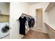 Walk-in closet with built-in shelving, a clothing rack, and a laundry area with a washing machine at 18107 W Thunderhill Pl, Goodyear, AZ 85338