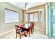 Cozy dining nook with a table, four chairs, tile flooring, and lots of natural light at 18107 W Thunderhill Pl, Goodyear, AZ 85338