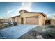 Beautiful home featuring a two-car garage, desert landscaping, and a covered porch entry at 18107 W Thunderhill Pl, Goodyear, AZ 85338