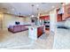 Modern kitchen open to living area, granite countertops, stainless steel appliances, and a center island at 18107 W Thunderhill Pl, Goodyear, AZ 85338
