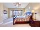 Serene main bedroom with carpet, a large window, a ceiling fan, and neutral paint at 18107 W Thunderhill Pl, Goodyear, AZ 85338