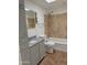 Functional bathroom with granite vanity, gray cabinet and shower over tub with tiled walls at 1822 E Roma Ave, Phoenix, AZ 85016