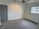 Bright bedroom features neutral carpeting, a ceiling fan and a sunny window at 1822 E Roma Ave, Phoenix, AZ 85016