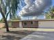 Charming single-story home with a neutral color scheme, stone accents, and well-maintained landscaping at 1822 E Roma Ave, Phoenix, AZ 85016
