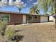 Single-story home featuring desert landscaping, stone accents, and a well-lit front entrance at 1822 E Roma Ave, Phoenix, AZ 85016
