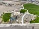Aerial shot of a modern park with walking paths, playground, and picnic area at 18353 W Gray Fox Trl, Wittmann, AZ 85361