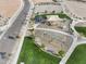 Aerial view of a modern playground and park with walking paths at 18353 W Gray Fox Trl, Wittmann, AZ 85361