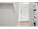 Hallway view of shower with decorative curtain, and shelving with towels at 18353 W Gray Fox Trl, Wittmann, AZ 85361