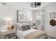 Bright bedroom featuring modern decor, two bedside lamps, and natural light at 18353 W Gray Fox Trl, Wittmann, AZ 85361
