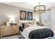 Cozy bedroom featuring a stylish bed, decorative pillows, ambient lighting, and elegant side tables at 18353 W Gray Fox Trl, Wittmann, AZ 85361
