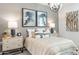 Comfortable bedroom with stylish lighting, neutral tones and decorative wall art at 18353 W Gray Fox Trl, Wittmann, AZ 85361