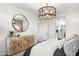 Bright bedroom featuring a modern chandelier, stylish furnishings, and neutral tones, creating a cozy and inviting atmosphere at 18353 W Gray Fox Trl, Wittmann, AZ 85361