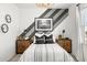 Nicely decorated bedroom with striped accent wall, modern lighting, and bright window at 18353 W Gray Fox Trl, Wittmann, AZ 85361