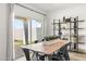 Dining area featuring a stylish table set near a sliding glass door and decorative shelving at 18353 W Gray Fox Trl, Wittmann, AZ 85361