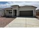 Charming single-story home featuring a two-car garage and drought-resistant landscaping at 18353 W Gray Fox Trl, Wittmann, AZ 85361