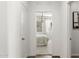 Bright hallway leading to a bedroom with neutral carpet and natural light at 18353 W Gray Fox Trl, Wittmann, AZ 85361