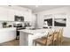 Well-lit kitchen boasts stainless steel appliances, a breakfast bar with seating, and tasteful décor at 18353 W Gray Fox Trl, Wittmann, AZ 85361
