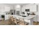 Spacious kitchen with a large island, stainless steel appliances and modern white cabinets at 18353 W Gray Fox Trl, Wittmann, AZ 85361