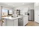 Bright kitchen featuring an island with white countertops, stainless steel appliances, and an open concept design at 18353 W Gray Fox Trl, Wittmann, AZ 85361