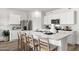 Modern kitchen features white cabinets, stainless steel appliances and a large island at 18353 W Gray Fox Trl, Wittmann, AZ 85361