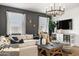 Inviting living room with a large sectional sofa, decorative pillows, modern lighting, and tasteful decor at 18353 W Gray Fox Trl, Wittmann, AZ 85361