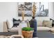 Close-up showcasing the living room's decorative elements, including vases, plants, and contemporary artwork at 18353 W Gray Fox Trl, Wittmann, AZ 85361