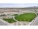 Scenic aerial view of a well-maintained community park with lush green lawns and playground, perfect for outdoor recreation at 18353 W Gray Fox Trl, Wittmann, AZ 85361