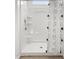 Bright shower featuring built-in shelving and a decorative curtain at 18353 W Gray Fox Trl, Wittmann, AZ 85361