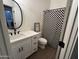 Bathroom featuring a modern vanity, a oval mirror and a checkered shower curtain at 1892 S Arroyo Ln, Gilbert, AZ 85295