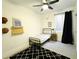 Nicely decorated bedroom with a bed, patterned rug, and a small window with dark curtains at 1892 S Arroyo Ln, Gilbert, AZ 85295