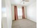 Small bedroom features neutral carpet, pink curtains, and a ceiling fan at 1892 S Arroyo Ln, Gilbert, AZ 85295