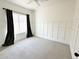 Cozy bedroom featuring wainscoting wall trim, carpet and a window with dark curtains at 1892 S Arroyo Ln, Gilbert, AZ 85295