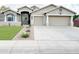 Charming home featuring a well-manicured lawn, a two-car garage, and a welcoming entrance at 1892 S Arroyo Ln, Gilbert, AZ 85295