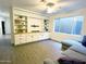 Inviting living room featuring built-in shelves, tv mount, and light wood flooring at 1892 S Arroyo Ln, Gilbert, AZ 85295