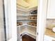 Well-organized walk-in pantry with multiple shelves and storage baskets for convenient kitchen storage at 1892 S Arroyo Ln, Gilbert, AZ 85295