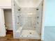 Modern tiled shower with dual shower heads, glass enclosure, and built-in bench seating at 1892 S Arroyo Ln, Gilbert, AZ 85295