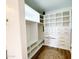Custom walk-in closet featuring built-in shelves, drawers, and ample storage space at 1892 S Arroyo Ln, Gilbert, AZ 85295
