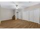 Bedroom with hardwood floors, neutral walls, ceiling fan, and a closet at 19616 N Toya St, Maricopa, AZ 85138