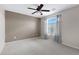 Bright bedroom featuring neutral walls, ceiling fan, and soft natural light at 19616 N Toya St, Maricopa, AZ 85138