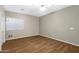 Bedroom with hardwood floors, neutral walls, ceiling fan, and a window at 19616 N Toya St, Maricopa, AZ 85138