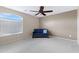 Cozy bedroom with a ceiling fan, neutral walls, and a comfortable seating area at 19616 N Toya St, Maricopa, AZ 85138