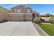 Charming two-story home featuring a spacious three-car garage and well manicured lawn and backyard patio at 19616 N Toya St, Maricopa, AZ 85138