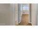 Hallway with hardwood floors, neutral walls, and a linen closet at 19616 N Toya St, Maricopa, AZ 85138