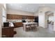 Well-lit kitchen features stainless steel appliances, center island with seating, and ample wood cabinets at 19616 N Toya St, Maricopa, AZ 85138