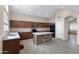 Bright kitchen features stainless steel appliances, center island with granite countertops, and ample wood cabinets at 19616 N Toya St, Maricopa, AZ 85138