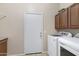 Functional laundry room with modern washer, dryer, and upper cabinets for storage at 19616 N Toya St, Maricopa, AZ 85138