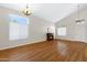 The bright and spacious living area has a fireplace and natural light from multiple windows and high ceilings at 19616 N Toya St, Maricopa, AZ 85138