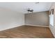 Bright living room features hardwood floors, neutral walls, and a ceiling fan at 19616 N Toya St, Maricopa, AZ 85138