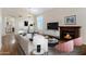 The open concept living area has a fireplace, modern decor and dining room with views of the backyard at 19616 N Toya St, Maricopa, AZ 85138