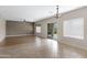 Bright living room with tile and hardwood floors and sliding glass door to the backyard at 19616 N Toya St, Maricopa, AZ 85138
